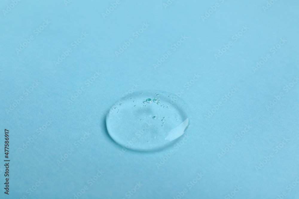 Drop of liquid transparent gel with bubbles on color background
