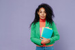 © ViDi Studio - Teacher serious elegant charismatic young black curly woman 20s wears green shirt looking camera holding in hands coloured textbooks isolated on plain pastel light violet background studio portrait.