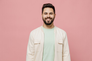 Wall Mural - Young smiling happy cheerful friendly fun european caucasian man 20s wearing trendy jacket shirt look camera isolated on plain pastel light pink background studio portrait. People lifestyle concept.