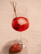 Select Spritz, a Red Venetian Aperetif with Prosecco from Italy, Served in a Wine Glass and Garnished with an Olve