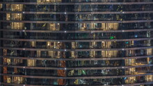 Outside View Of Windows In Apartments Of A High Class Building At Night Timelapse