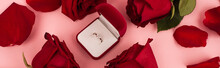 Flat Lay Of Red Rose Petals Around Jewelry Box With Diamond Ring On Pink, Banner.