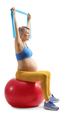 Wall Mural - Pregnant woman sitting on a fitness ball and exercising with a resistance band