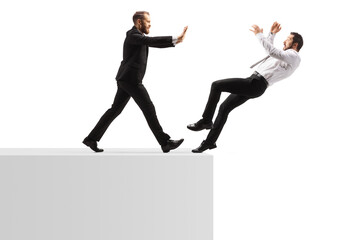 Wall Mural - Full length profile shot of a businessman pushing a man from a wall