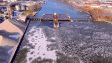 Low Flyover, Scenic View Of Old Fashioned Railroad Train Trestle Bridge Across Icy River.
