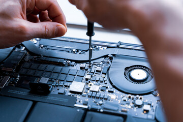 Wall Mural - Computer fixing. Maintenance repair engineer support. Pc technician service with laptop on hardware technology background. Engineer fixing broken computer motherboard.