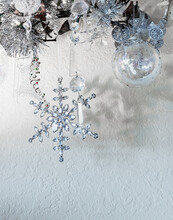 White And Silver Christmas Decorations With A Six Pointed Snowflake.