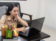 © PK Studio - Asian woman works with a computer at home
