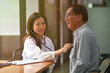 © saltdium - Photo of female doctor checks the elderly patient's heart pulse with a stethoscope in the modern health care center.
