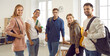 © Studio Romantic - Indoor group portrait of happy positive diverse fellow students. Five confident mixed race multiethnic university friends with bags standing together in modern classroom, smiling and looking at camera