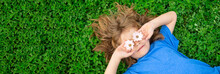 Banner With Spring Child Face. Spring Kid. Happy Child Enjoying On Grass Field And Dreaming. Funny Little Boy With Daisy In Eyes. Kids On Green Grass Background.