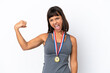 © luismolinero - Young mixed race woman with medals isolated on white background doing strong gesture