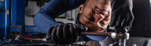 Positive African American Workman Using Wrench While Working In Car Service, Banner.