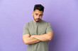 © luismolinero - Young caucasian man isolated on purple background with unhappy expression