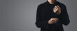 business man fixing his cufflink with copy space for text on the grey background.