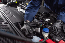 Cropped View Of Mechanic In Work Gloves Fixing Engine Of Car.