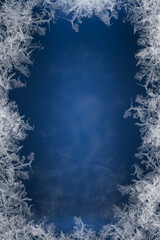 Wall Mural - Frosty frame. Decorative ice crystals frame on dark blue background