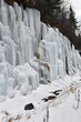 Icicles and road winding through the mountains with ice and snow, winter in the Adirondacks New York