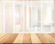 © tai - Empty wooden table top with blur image of a door in the hotel interior nature guest room in the daytime perspective background, copy space for your text ready for product promotion display montage