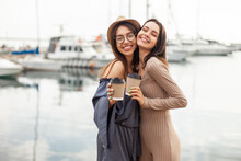 Two Cute Women Friend With Coffee Cups At The Yacht Club