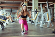 © splitov27 - Young smiling fit woman strides with barbell in gym