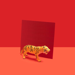 Abstract concept of Chinese tiger zodiac new year celebration with red card beside. Red background behind.