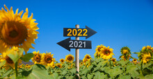 2021 And 2022 Road Signs In The Sunflower Garden.Happy New Year Background. Successful Start To The New Year.