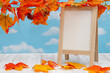 Blank standing whiteboard on weathered wood with fall leaves
