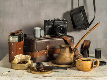 A Cup Of Aromatic Coffee. A Smoking Pipe And A Box Of Tobacco. Old Film Cameras, Photographic Film, Leather Case For Photographic Equipment. Old Photographic Equipment. Film Photography Nastalgia.