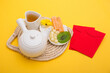 Tet concept. Lunar new year, Tet holiday. Tet holiday sweet food with set of tea isolated on yellow