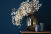Dried Flowers Stand In A Transparent Vase On The Table