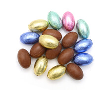 Chocolate Easter Eggs In Colorful Foil On White Background