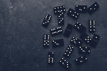 Old Black Domino Chips Scattered Around The Table In Vintage Style