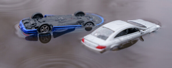 Two cars were flooded, one overturned as a result of the flood. One of them is out of focus.