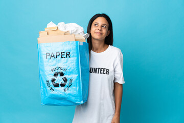 Poster - Young woman holding a recycling bag full of paper thinking an idea while looking up