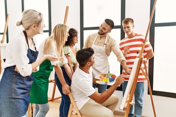 Poster - Group of people smiling happy and looking draw of partner at art studio.