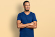 © Krakenimages.com - Young african american man with arms crossed gesture winking looking at the camera with sexy expression, cheerful and happy face.