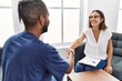 © Krakenimages.com - Man and woman having psychology session shake hands at psychology clinic