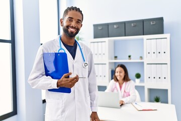 Sticker - Man and woman wearing doctor uniform smiling confident working at clinic