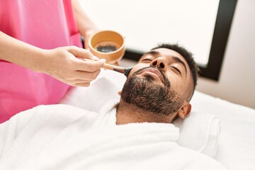 Sticker - Man reciving facial treatment at beauty center.