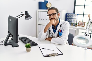 Wall Mural - Handsome hispanic man working as doctor at hospital clinic