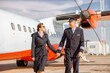 © Kostiantyn - Airplane pilot and his wife waking hand in hand at airport