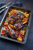 Fototapeta Dmuchawce - Traditional braised slow cooked Australian lamb shank with pineapple and pomegranate served as close-up in a backing form