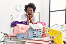 Young African American Woman Boring Doing Laundry At Laundry