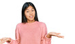 © Krakenimages.com - Beautiful young asian woman wearing casual winter sweater clueless and confused expression with arms and hands raised. doubt concept.