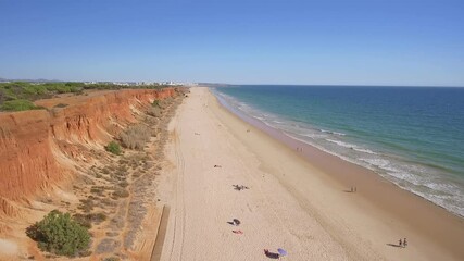 Wall Mural - Aerial video of the beautiful Portuguese southern beaches of Falesia. Sandy mountains tourists on vacation.