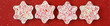 Winter treat, snowflake shaped Peppermint Bark chocolate candy on a festive red background
