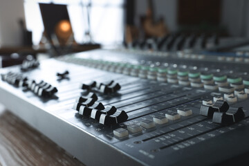 Professional mixing console on table in radio studio, closeup