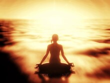 光を浴びて瞑想する女性のシルエット