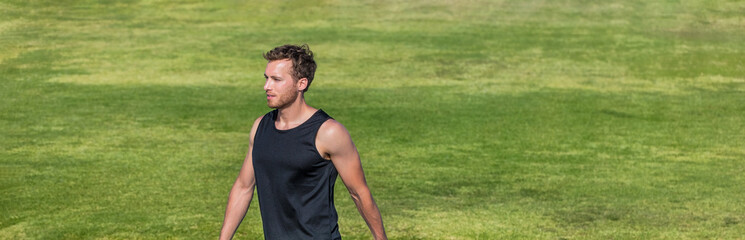 Wall Mural - Man portrait fit athlete male model on grass background Panoramic banner. Runner outside preparing for workout exercise training.